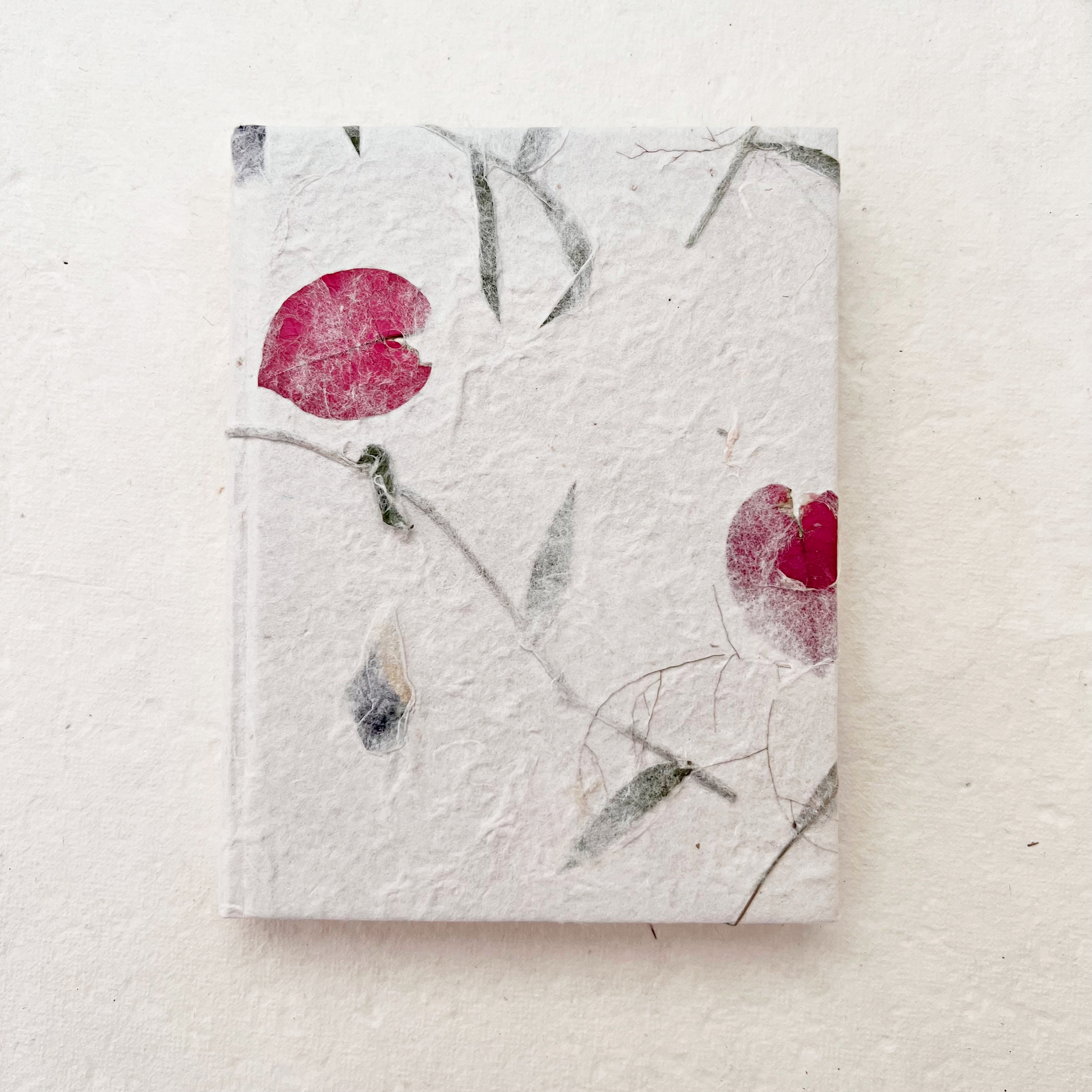 Notebook size 15x11cm flowermixed mulberry paper on the cover, 64 pgs ivory paper